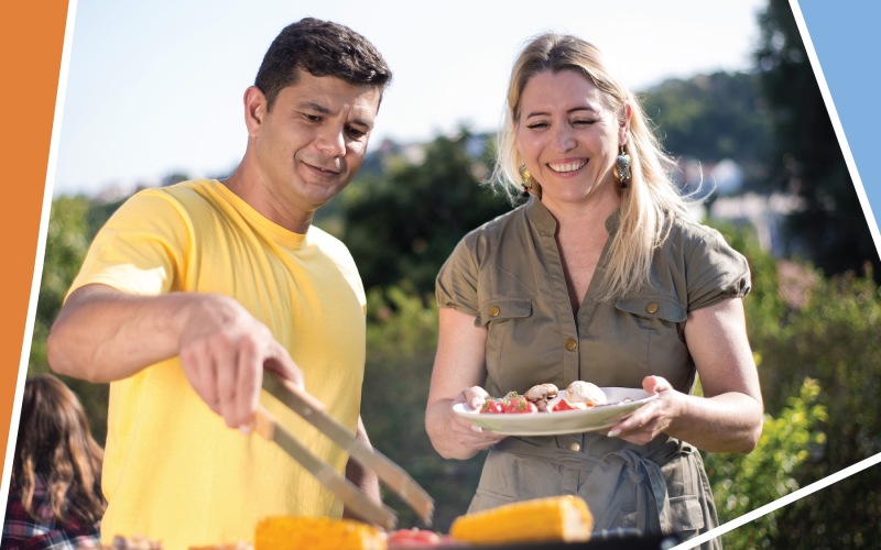 a man and woman holding a plate of food