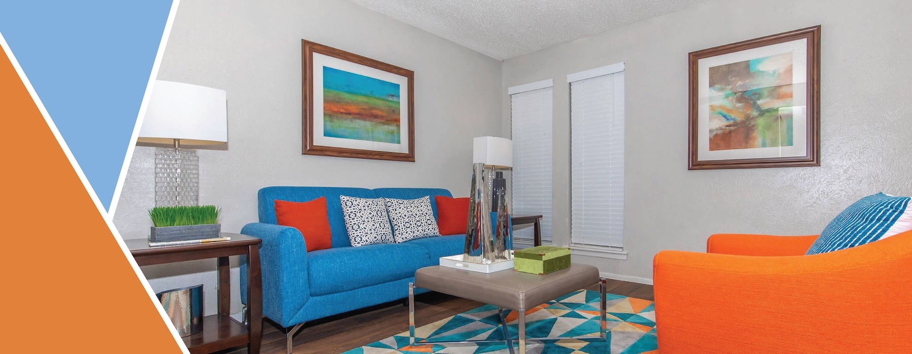 a living room with a blue couch and a coffee table