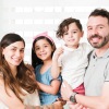 a family posing for a picture in a kitchen