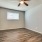 a bedroom with a ceiling fan and a window
