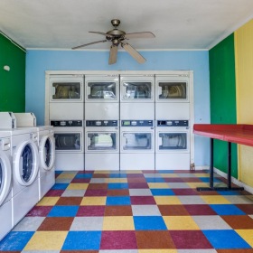 a large community laundry area with a table