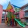 a colorful playground in front of a building